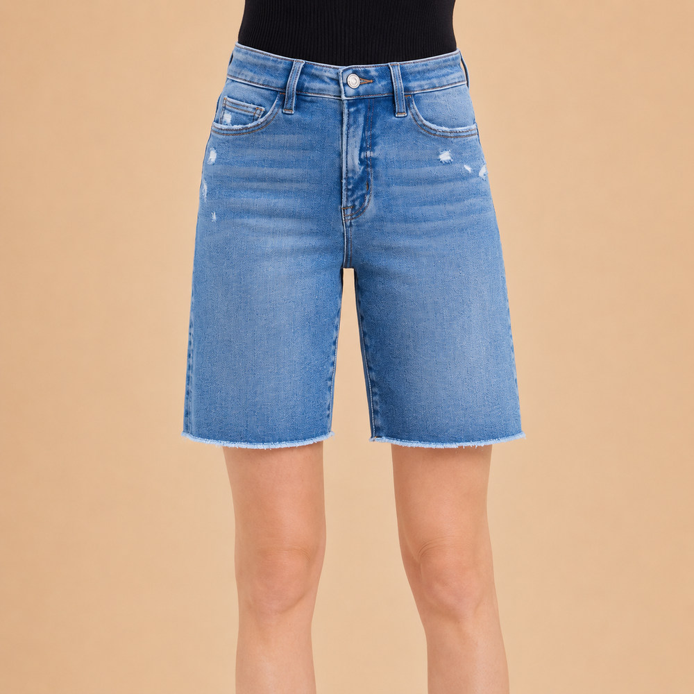 Blue denim shorts on a beige background