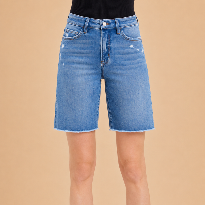 Blue denim shorts on a beige background