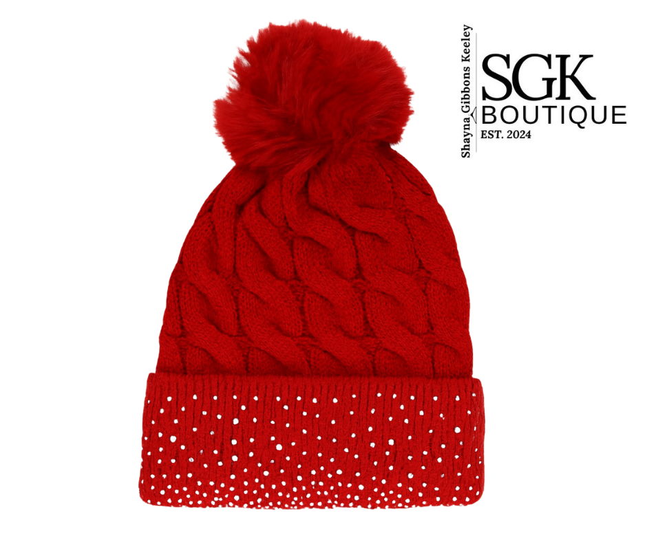 Red knit beanie with a pom-pom on a white background, featuring the SGK Boutique logo.