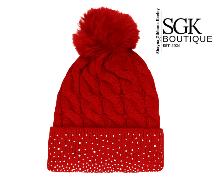 Red knit beanie with a pom-pom on a white background, featuring the SGK Boutique logo.