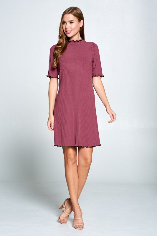 Woman wearing a maroon dress on a white background