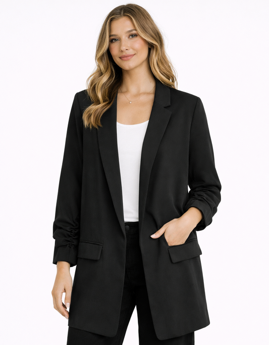 Woman wearing a black suit with a white top on a white background