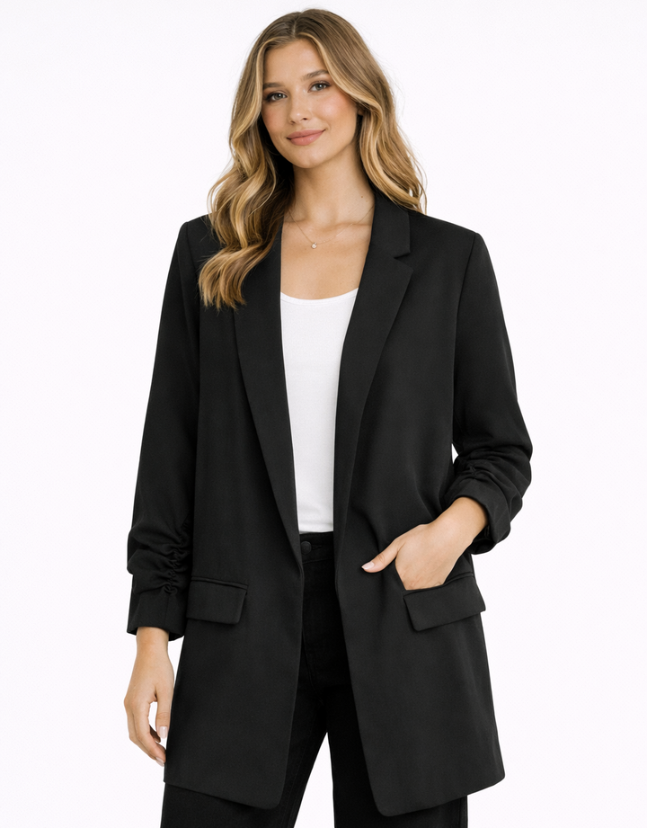 Woman wearing a black suit with a white top on a white background