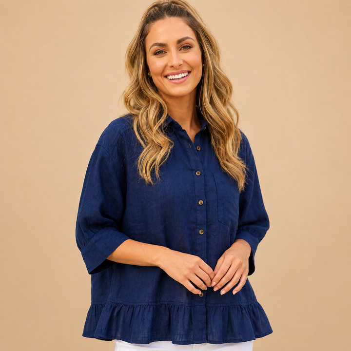 Woman wearing a navy blue blouse with a beige background