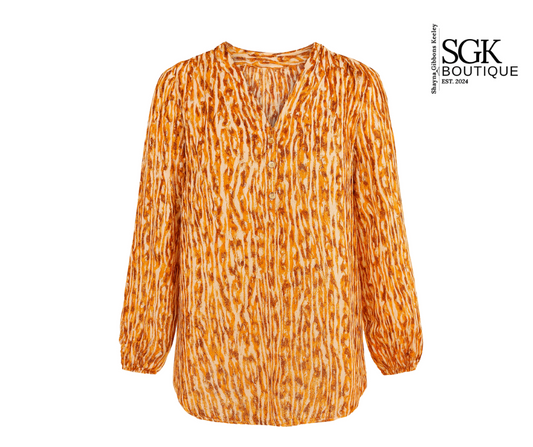 Orange patterned blouse on a white background with SGK Boutique logo.