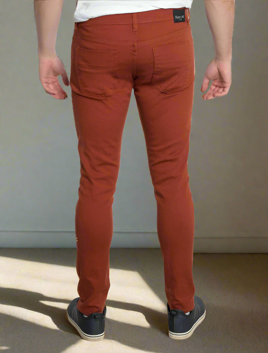 Orange pants worn by a person on a white background