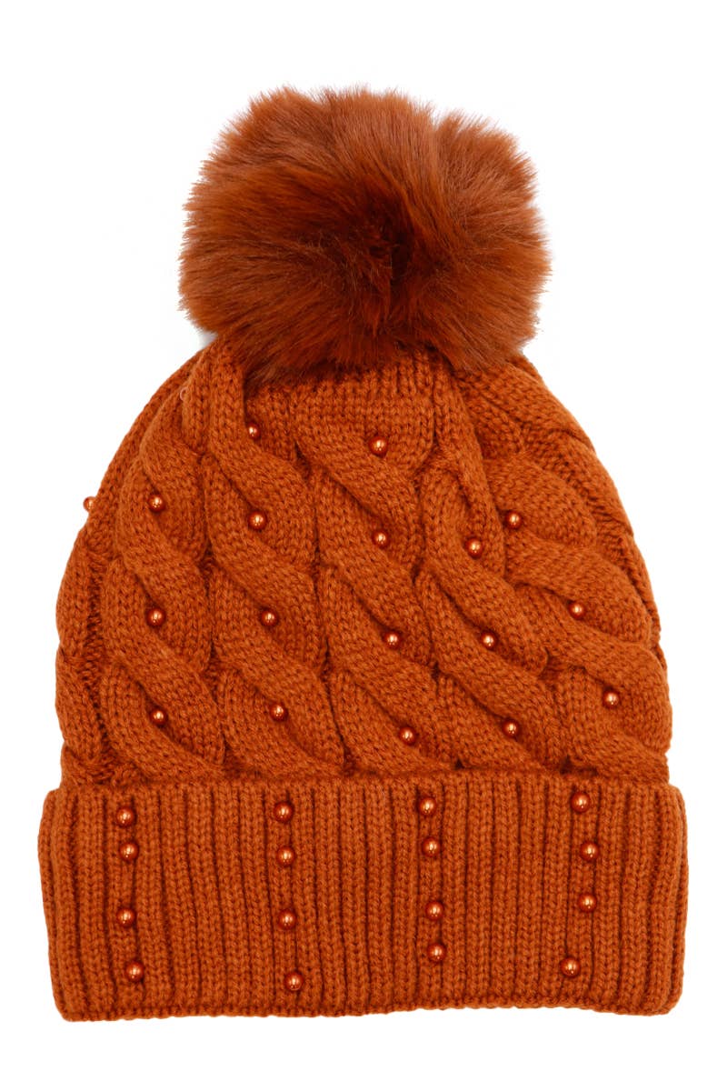 Orange knitted beanie with a pom-pom on a white background