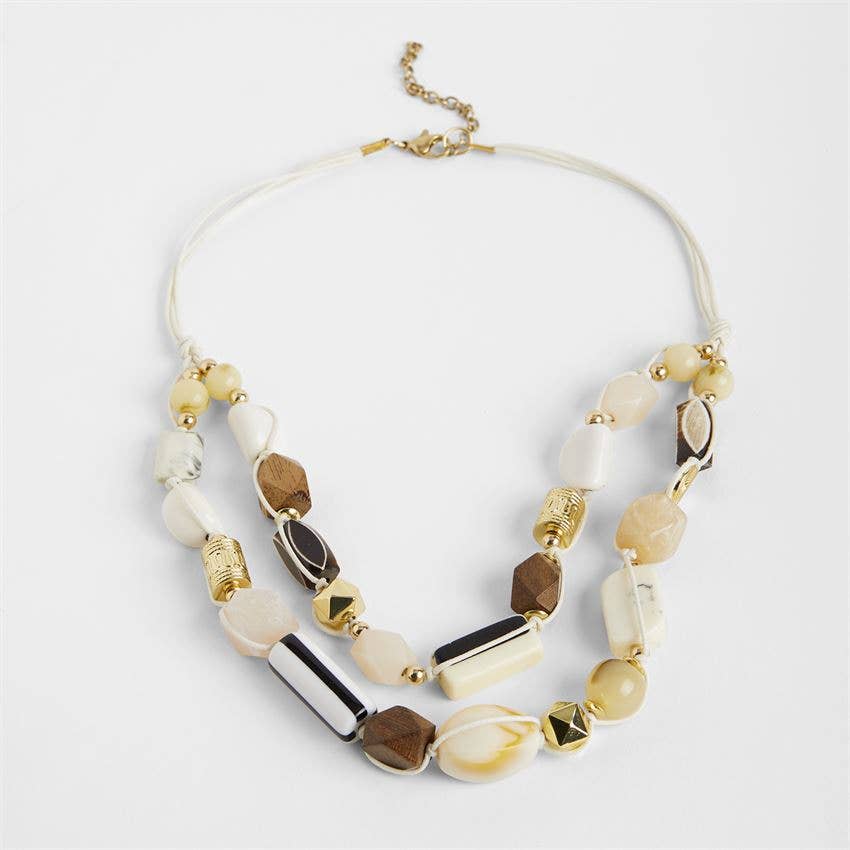 Necklace with multicolored beads on a light gray background