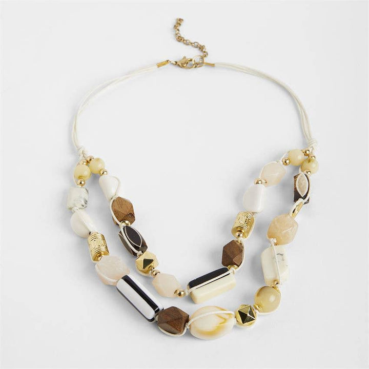 Necklace with multicolored beads on a light gray background