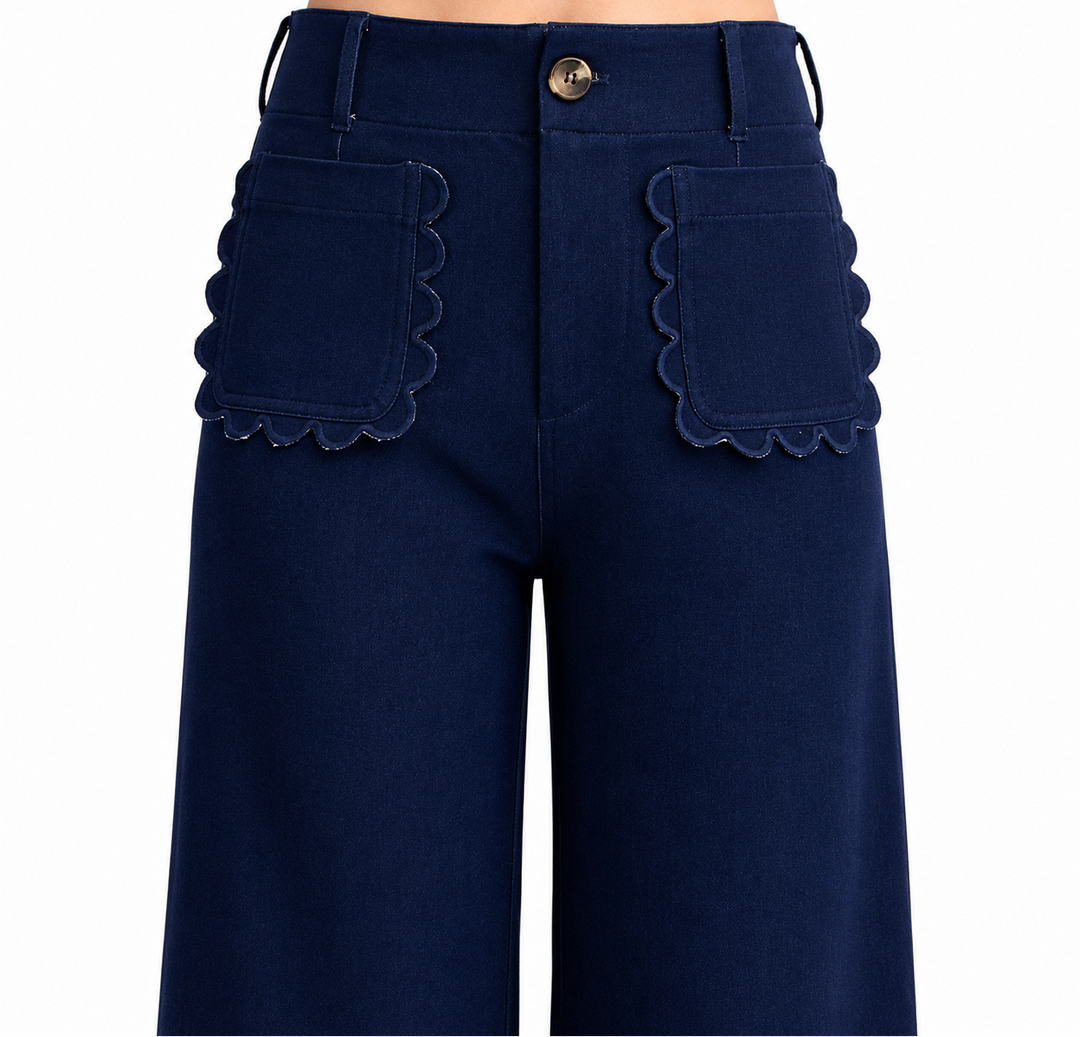 Navy blue pants with scalloped pocket details on a white background