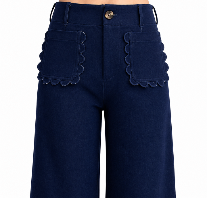Navy blue pants with scalloped pocket details on a white background