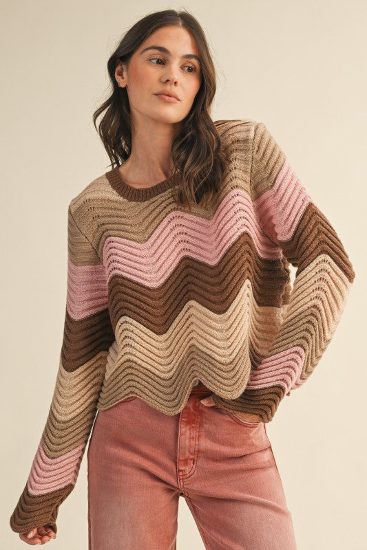 Woman wearing a striped sweater with wavy pattern on a beige background