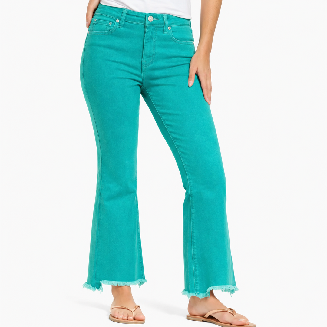 Teal jeans worn by a person on a white background