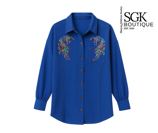 Blue shirt with floral embroidery on the chest, featuring SGK Boutique logo.