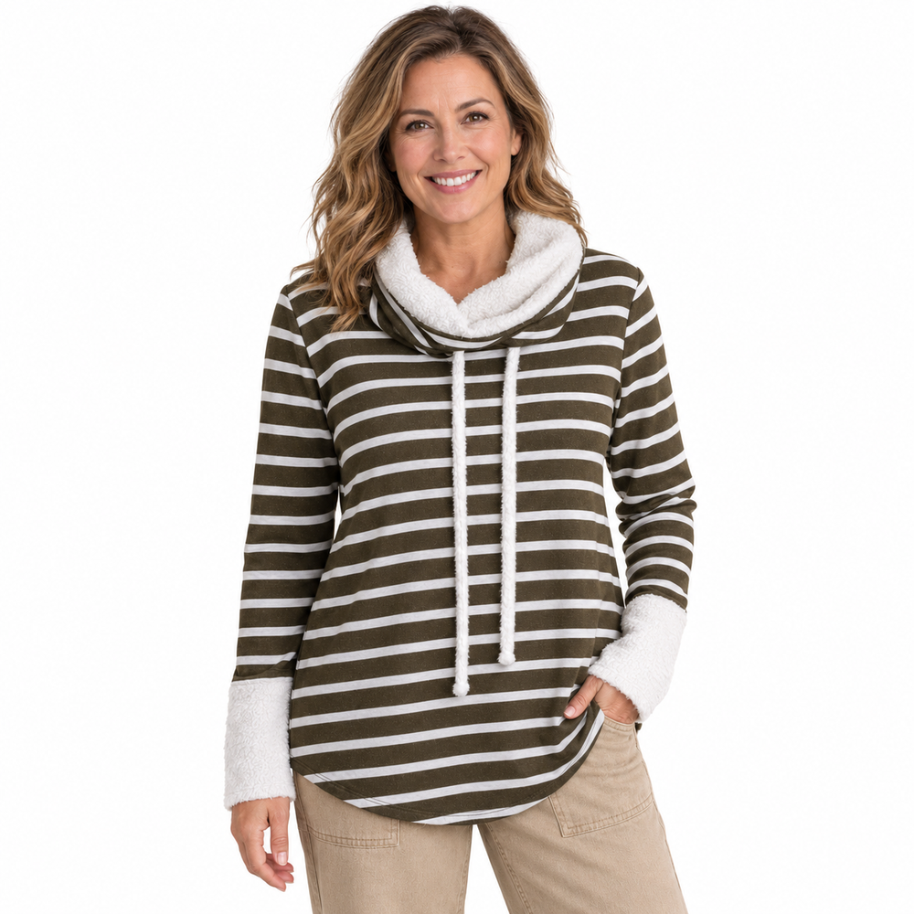 A woman modeling a brown and white horizontally striped cowl neck pullover hoodie with a white sherpa-lined hood and white drawstrings, paired with khaki pants against a solid white background.