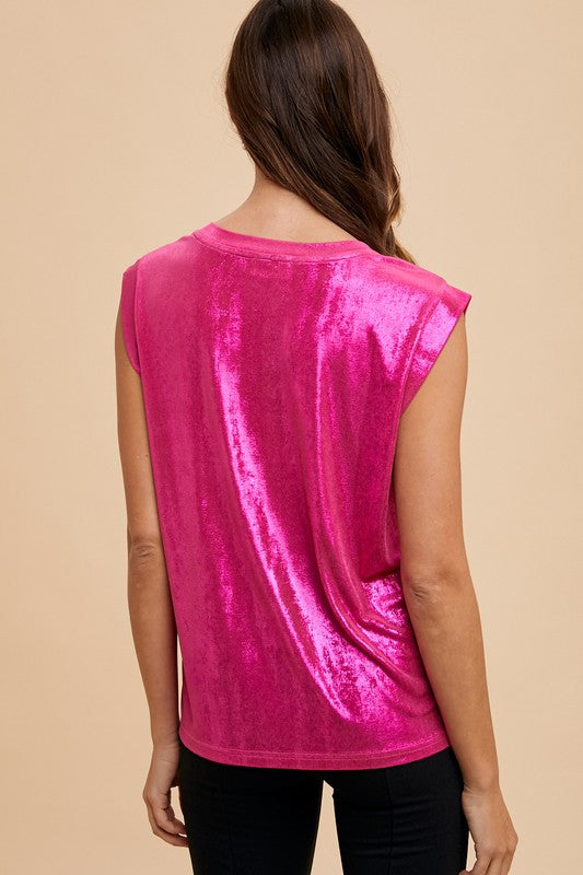 Person wearing a bright pink sleeveless top against a neutral background.