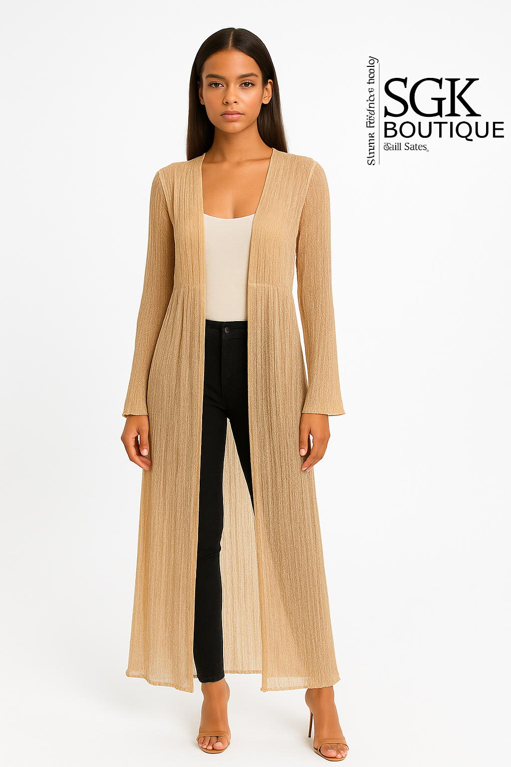 Woman wearing a beige long cardigan over a white top and black pants on a white background with &