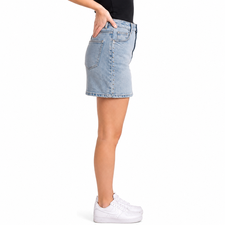 Light blue denim skirt worn by a person on a white background