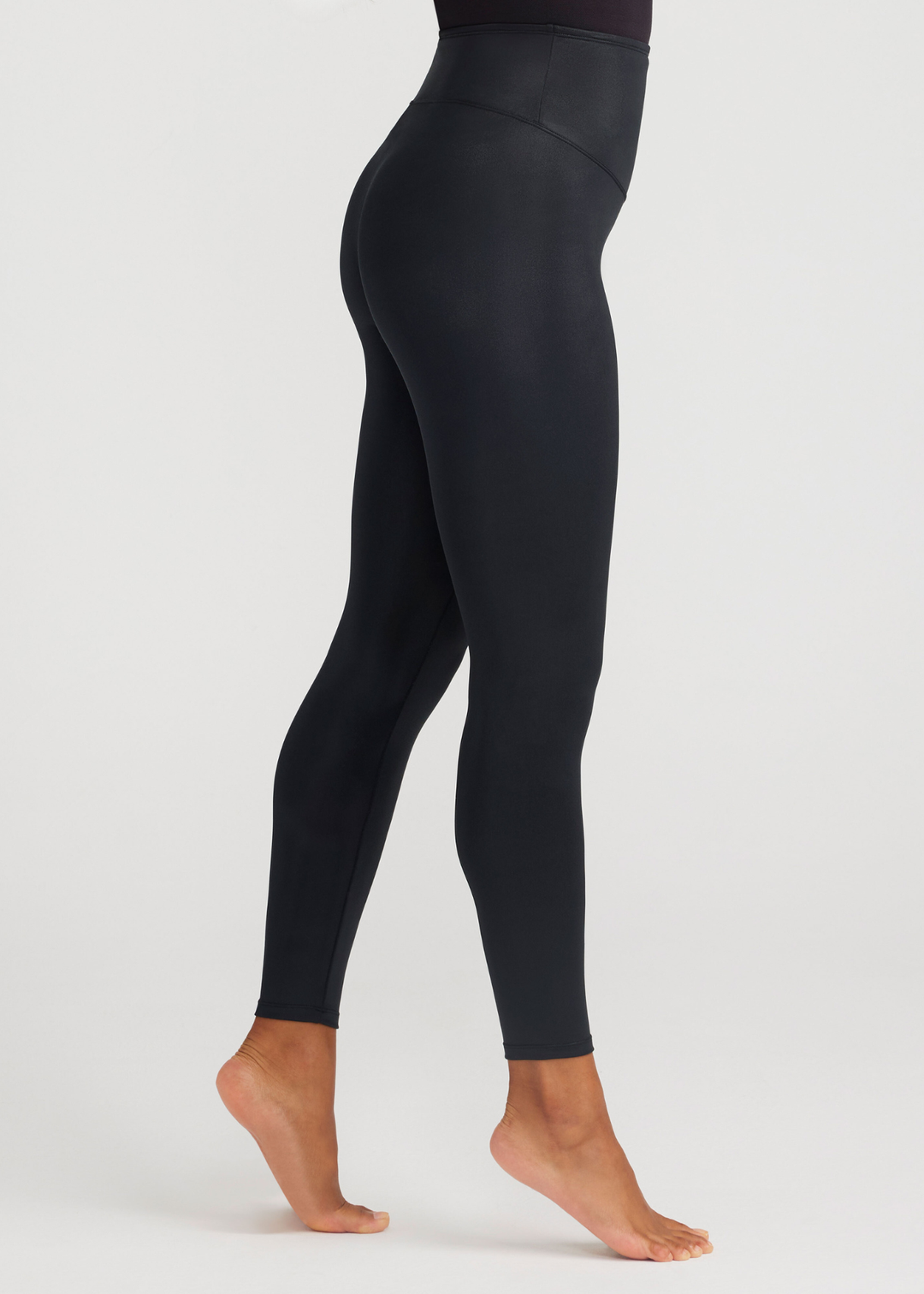 Black leggings worn by a person on a white background