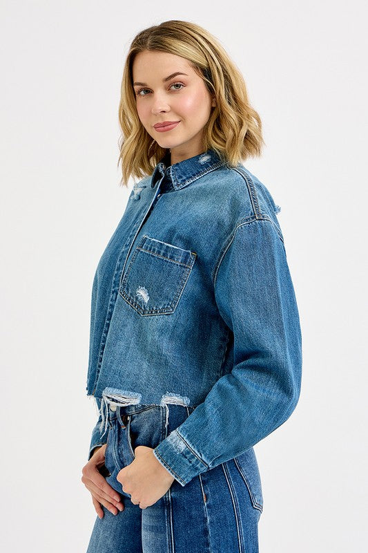 Woman wearing a blue denim jacket on a white background