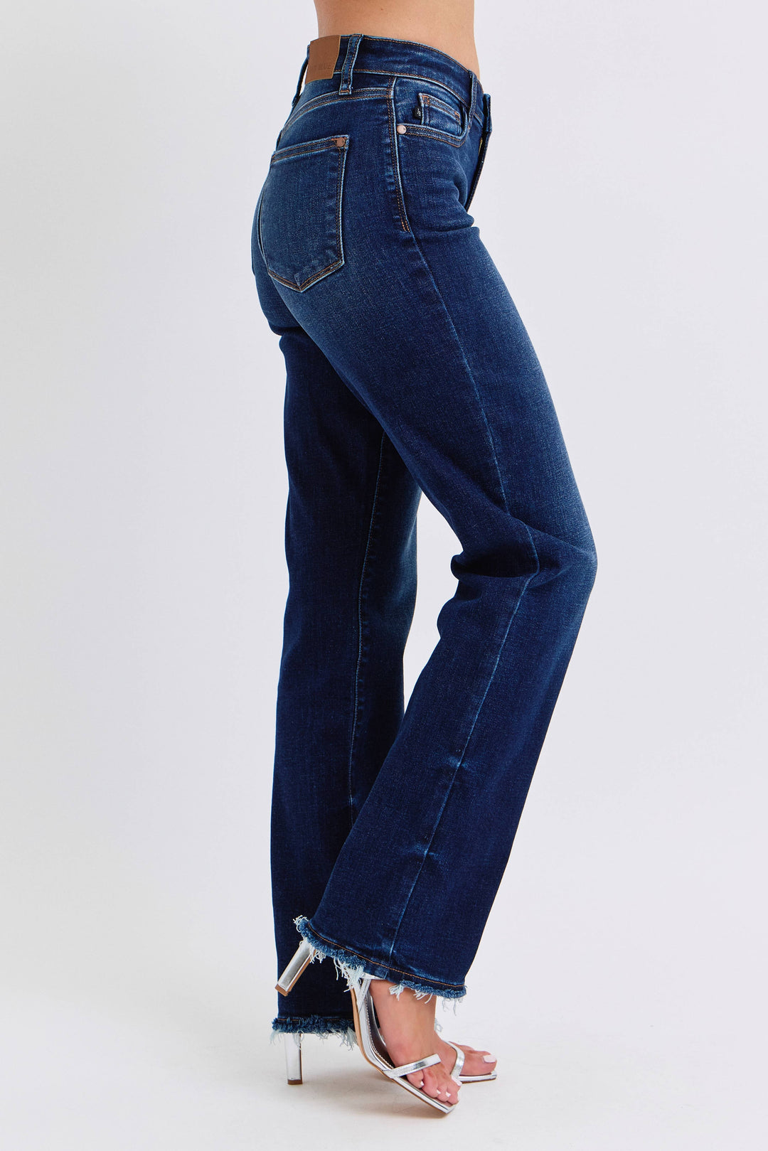 Blue jeans worn by a person on a white background