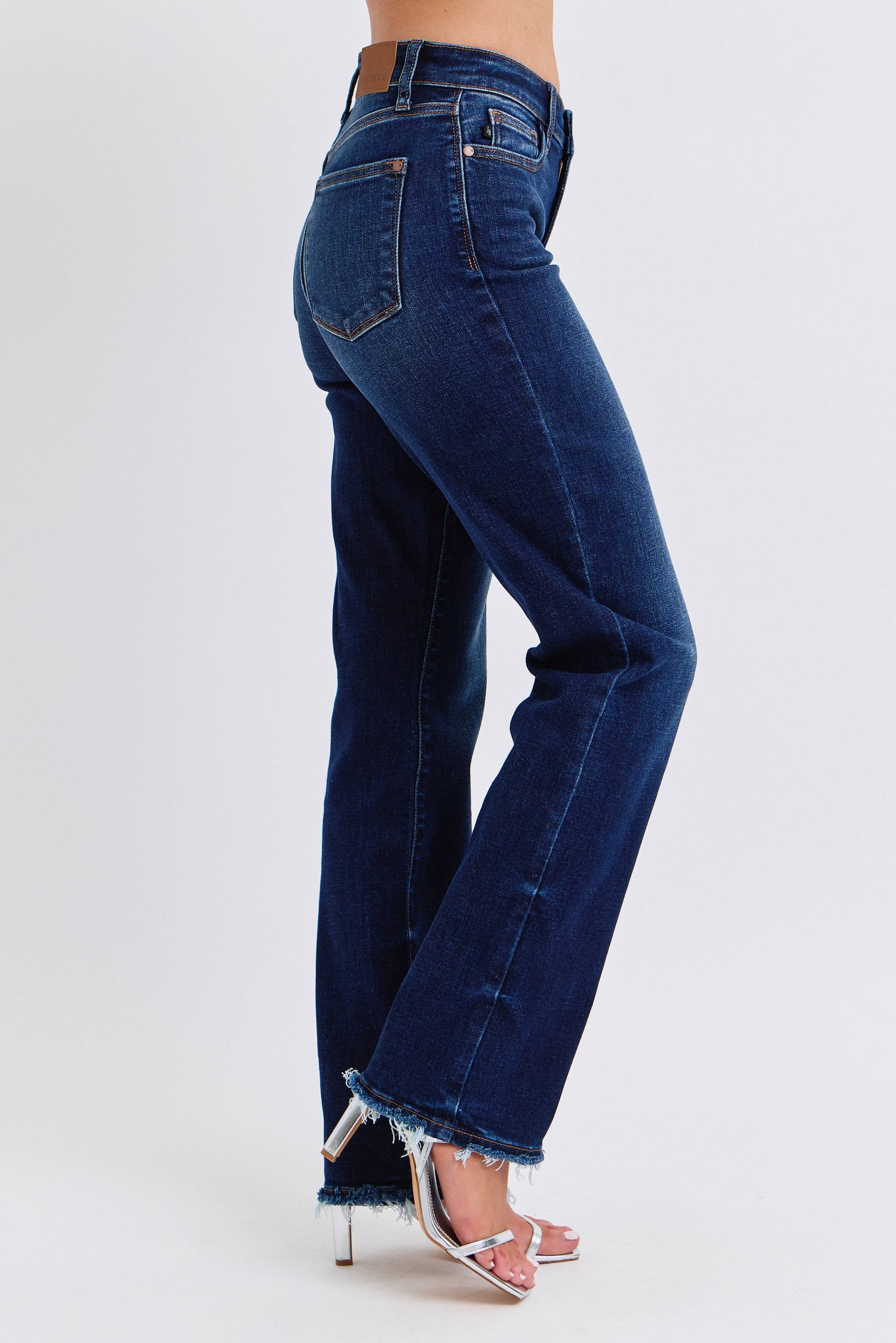 Blue jeans worn by a person on a white background