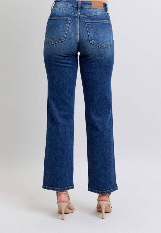 Blue jeans worn by a person on a white background