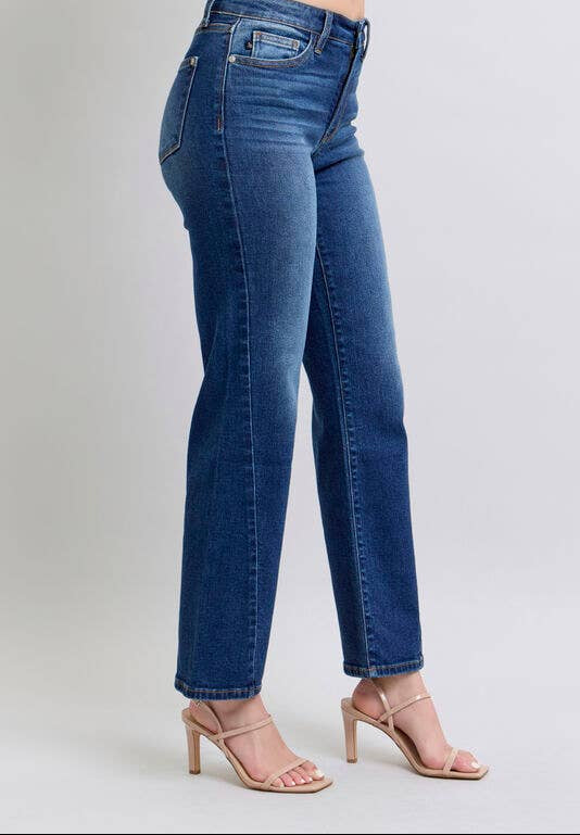 Blue jeans worn by a person on a light gray background