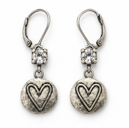 A pair of silver leverback earrings with a round textured heart pendant and a clear faceted crystal above each heart, shown on a plain white background.
