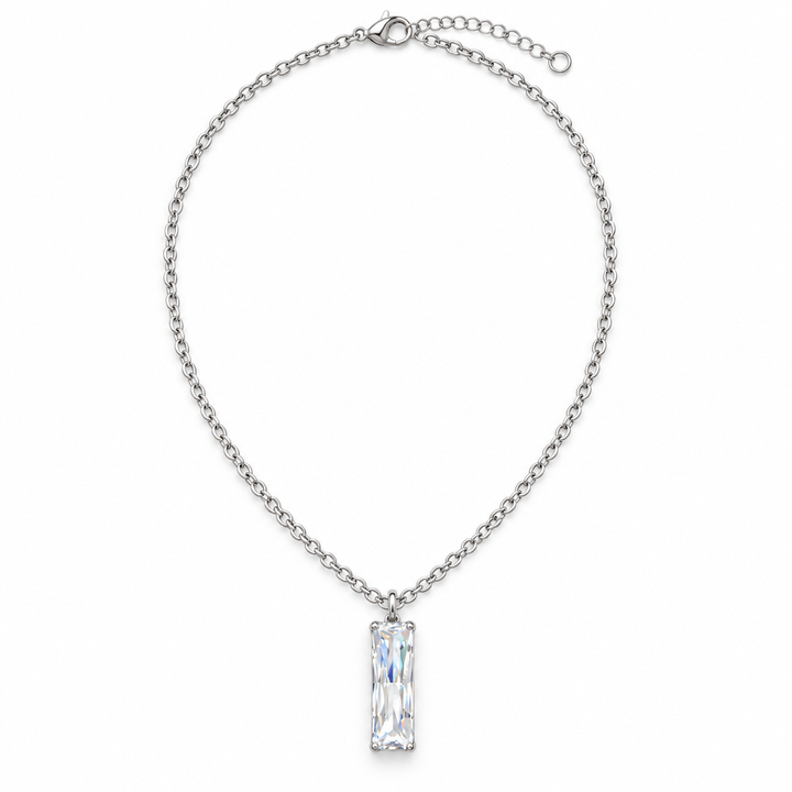 A silver chain necklace featuring a clear rectangular baguette-cut gemstone pendant, displayed against a solid white background.