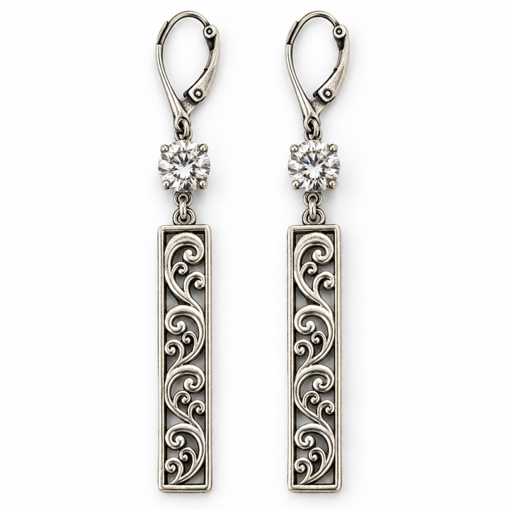 A pair of silver drop earrings with leverback hooks, round clear gemstones, and elongated rectangular filigree charms with scrollwork patterns, shown on a plain white background.
