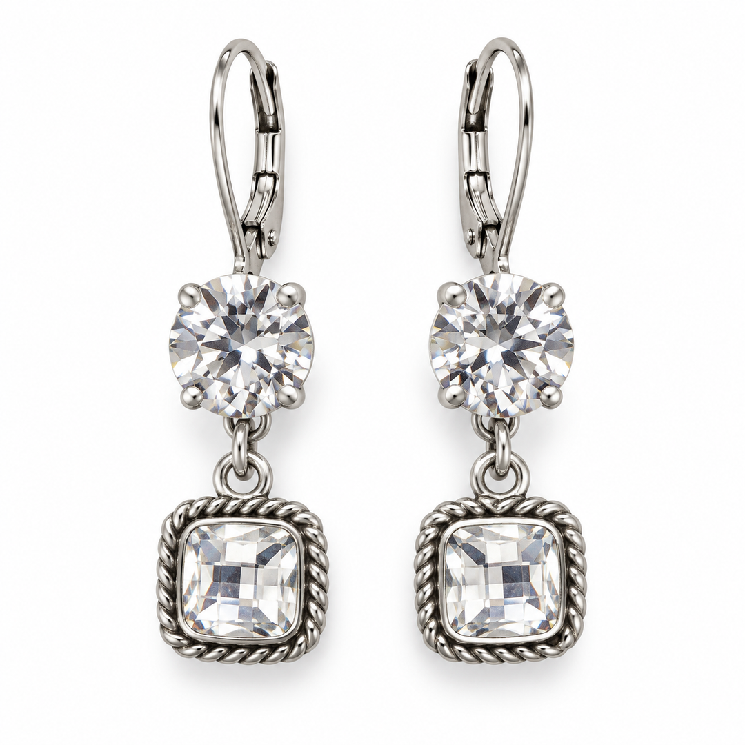 A pair of silver leverback drop earrings featuring a round clear crystal and a square cushion-cut clear crystal, both set in silver-toned metal with a rope-textured border on a white background.