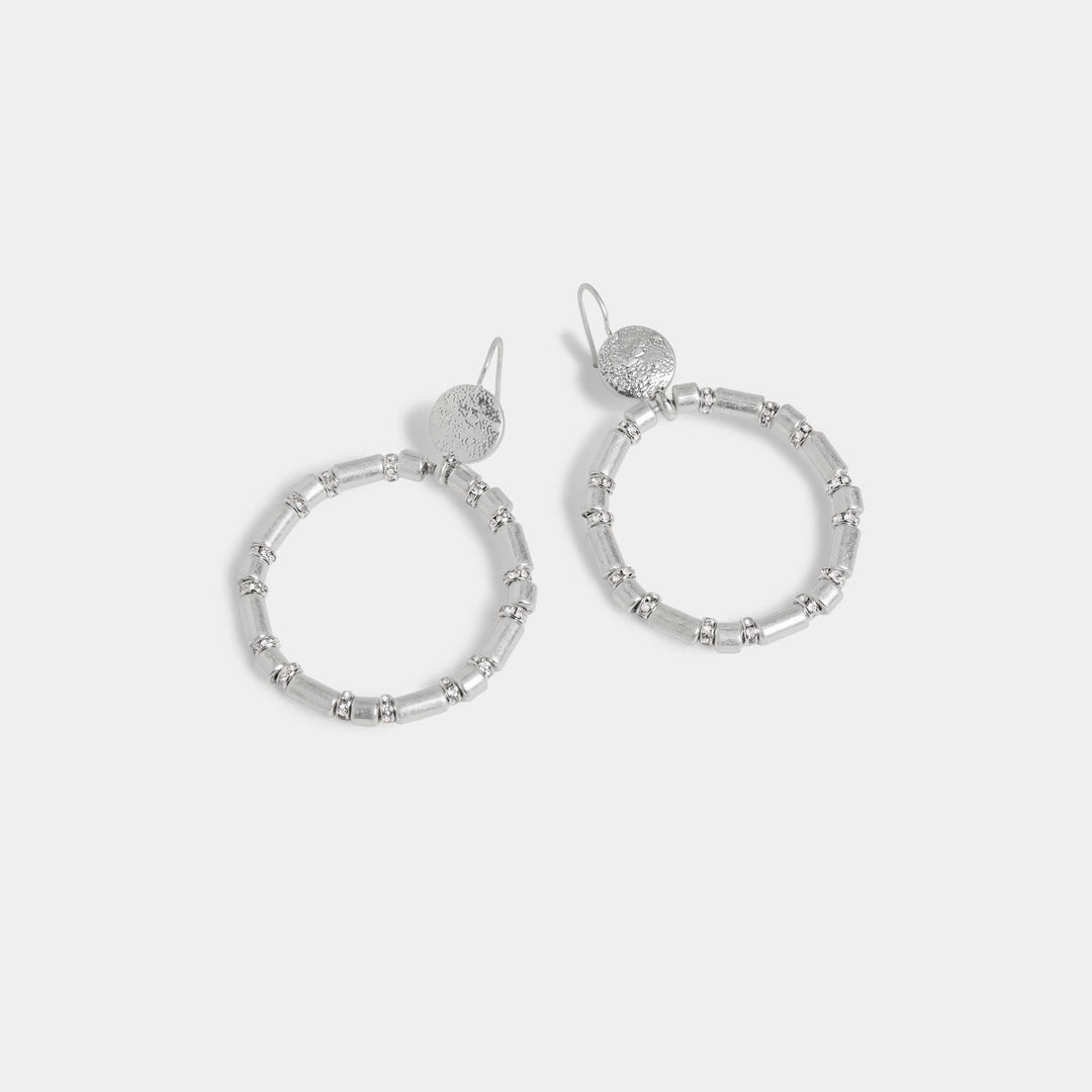 Silver hoop earrings on a light gray background