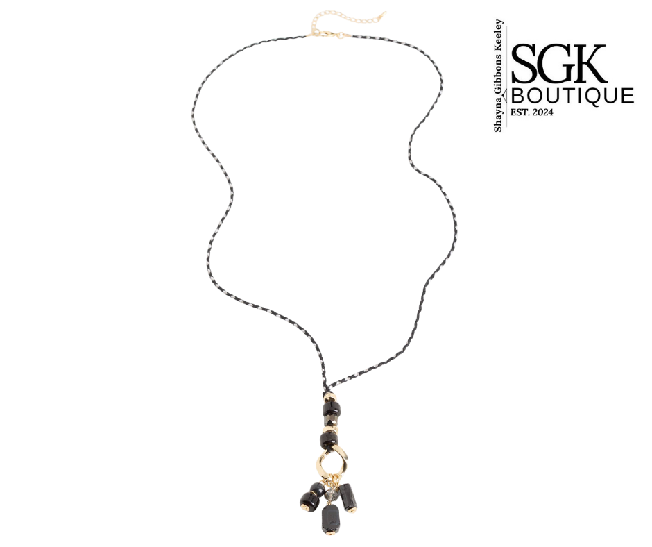 Necklace with black beads and gold accents on a white background, featuring SGK Boutique logo.