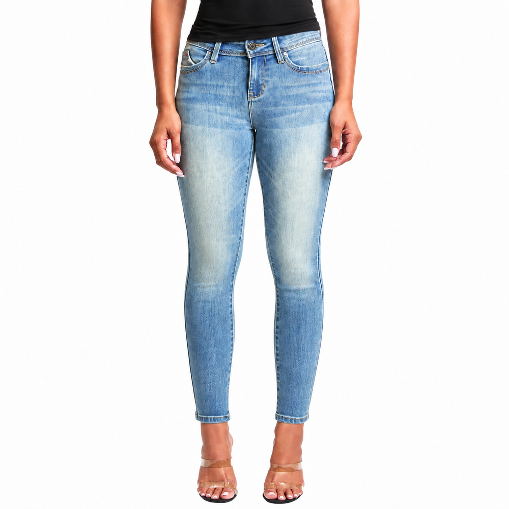 A model wearing light blue skinny jeans with a faded wash, paired with a black top and clear high-heeled sandals, shown against a plain white background.