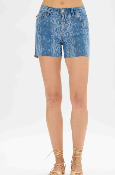 Blue acid-wash denim shorts worn by a person on a white background