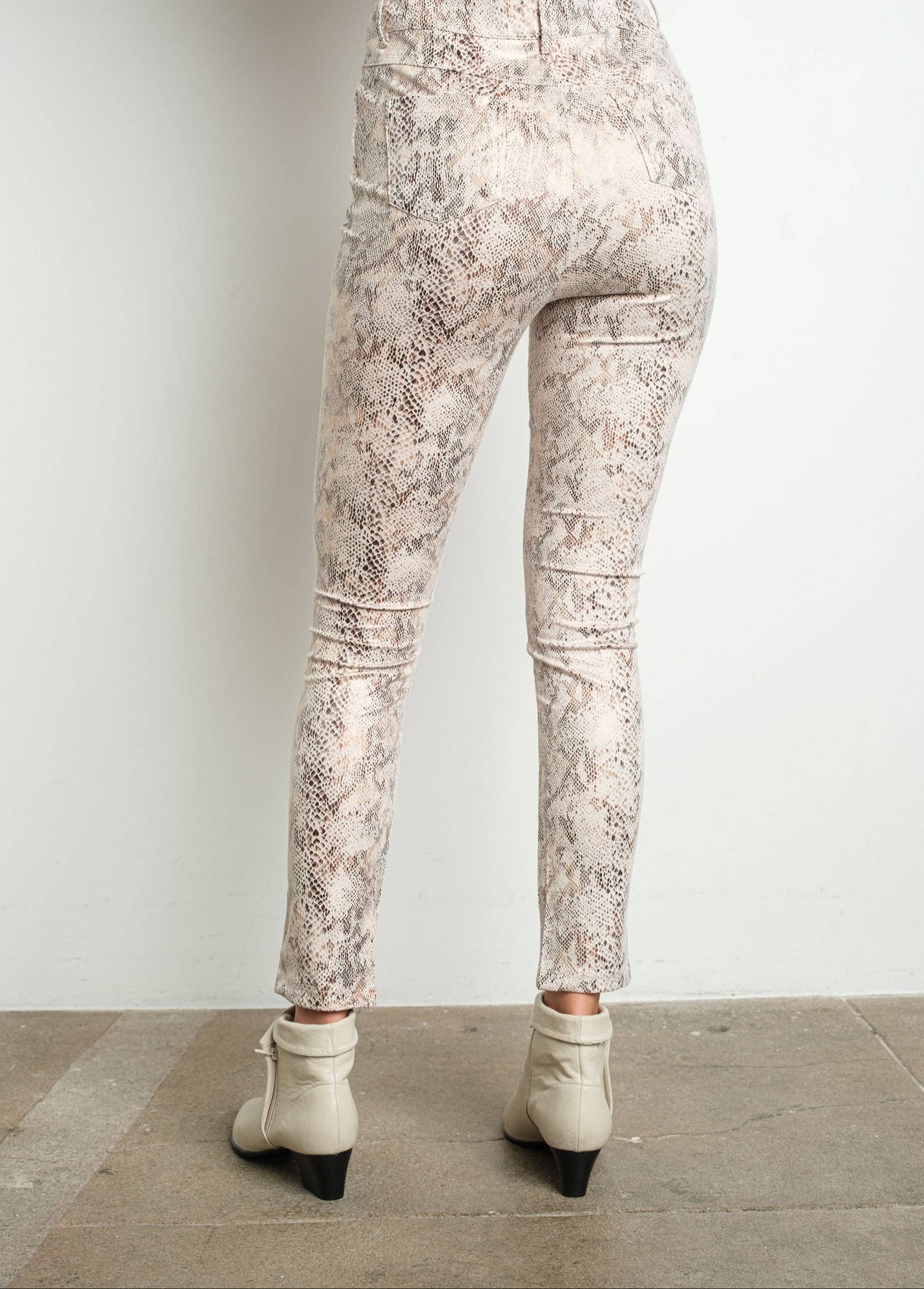 Patterned pants worn by a person on a plain background