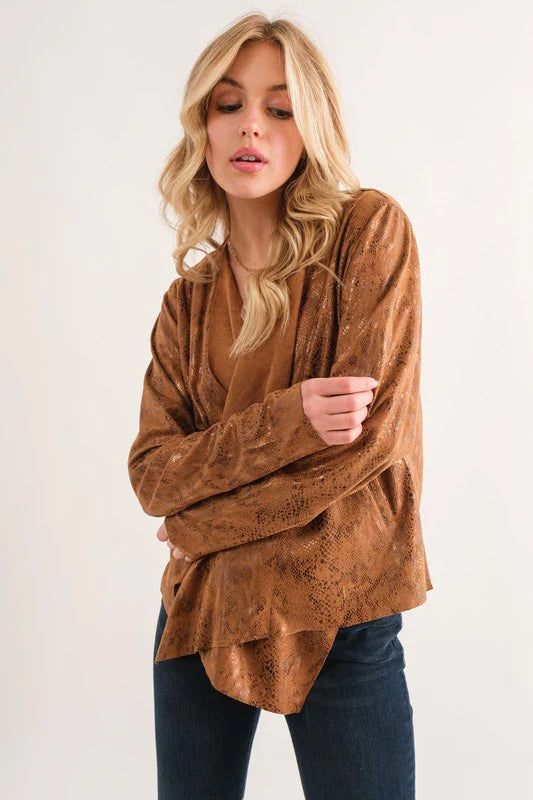 Woman wearing a brown suede jacket on a white background