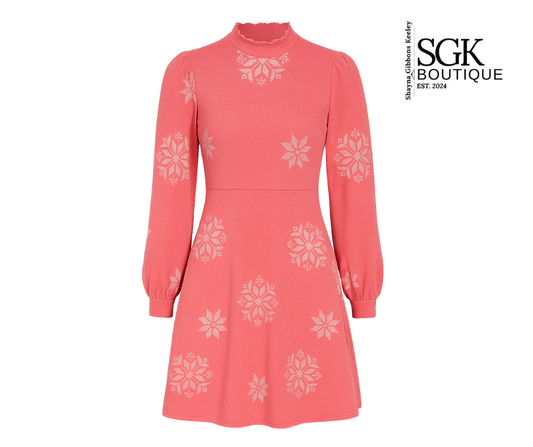 Pink dress with white floral patterns on a white background, featuring the SGK Boutique logo.