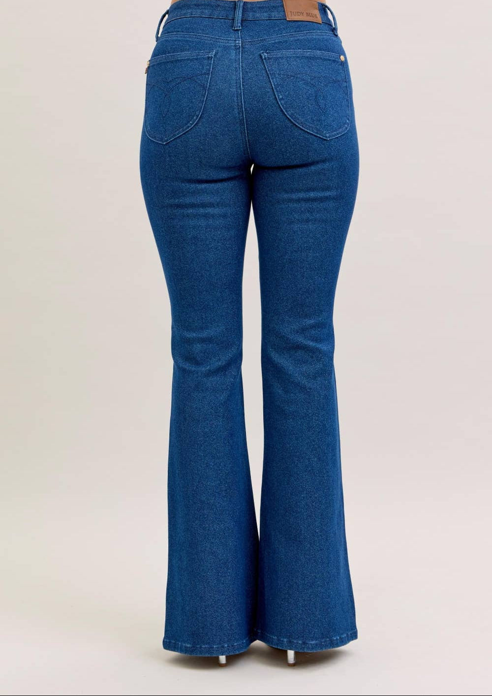 Blue flared jeans on a plain background