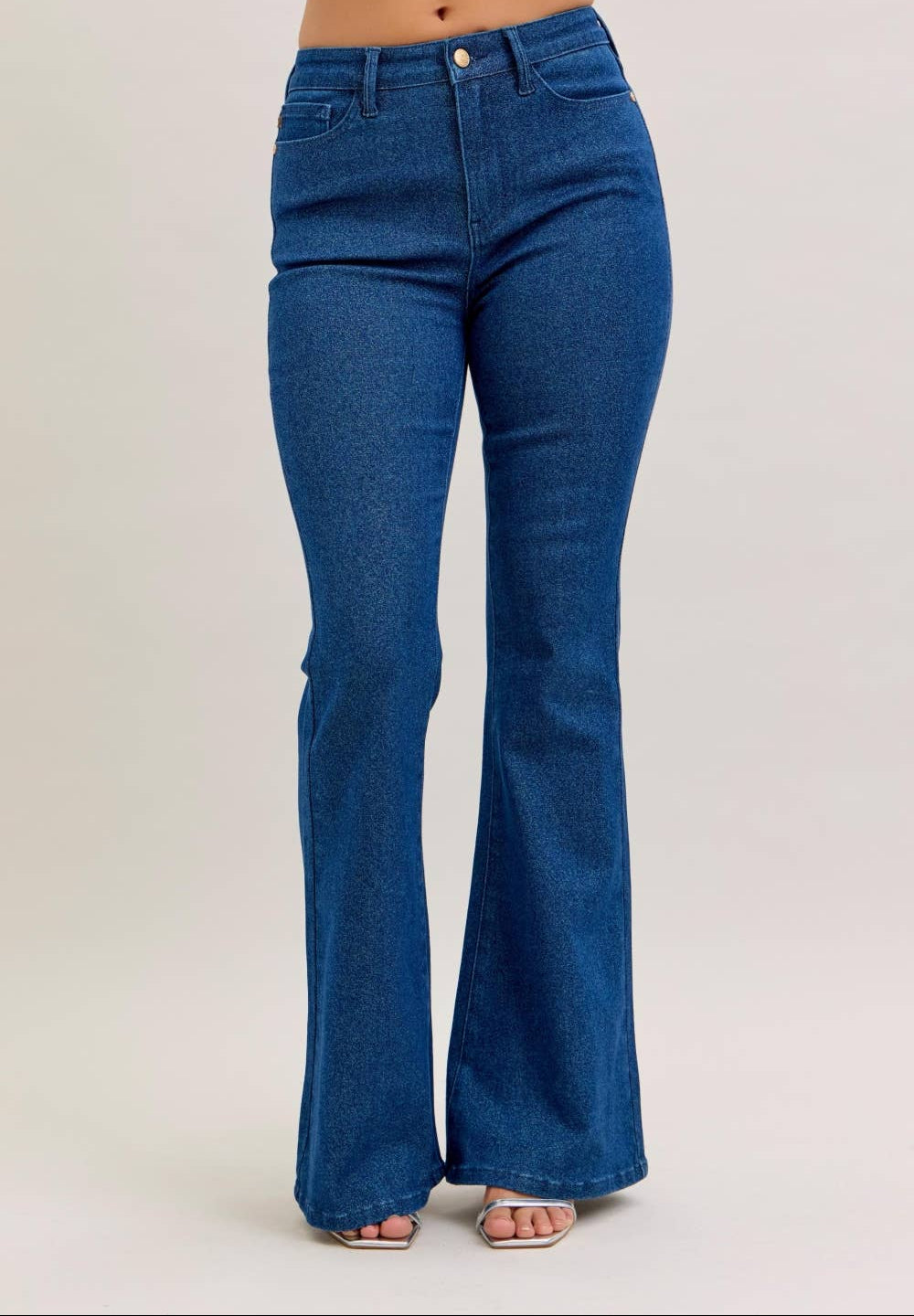 Blue flared jeans on a plain background