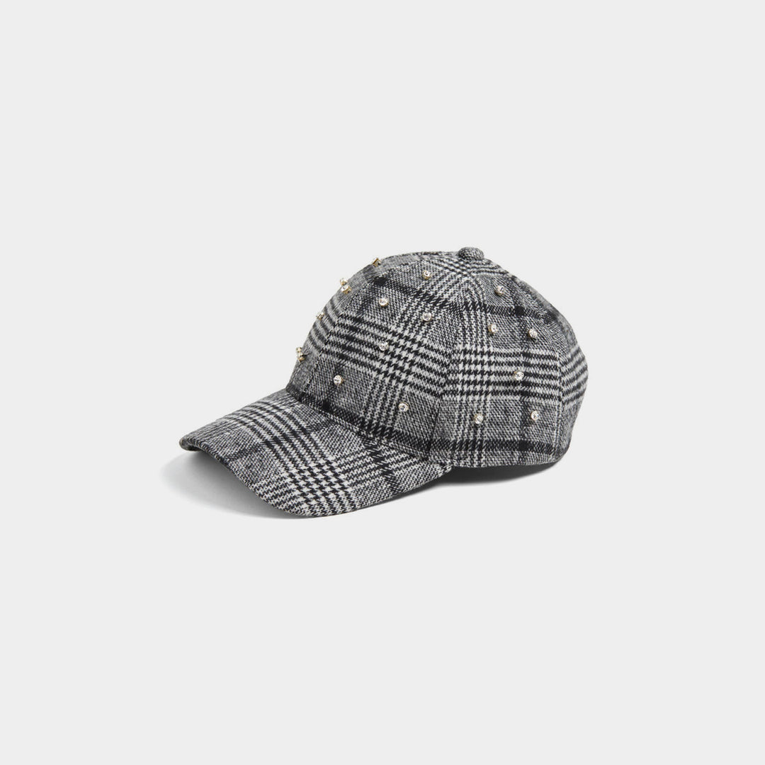Plaid baseball cap with embellishments on a light gray background