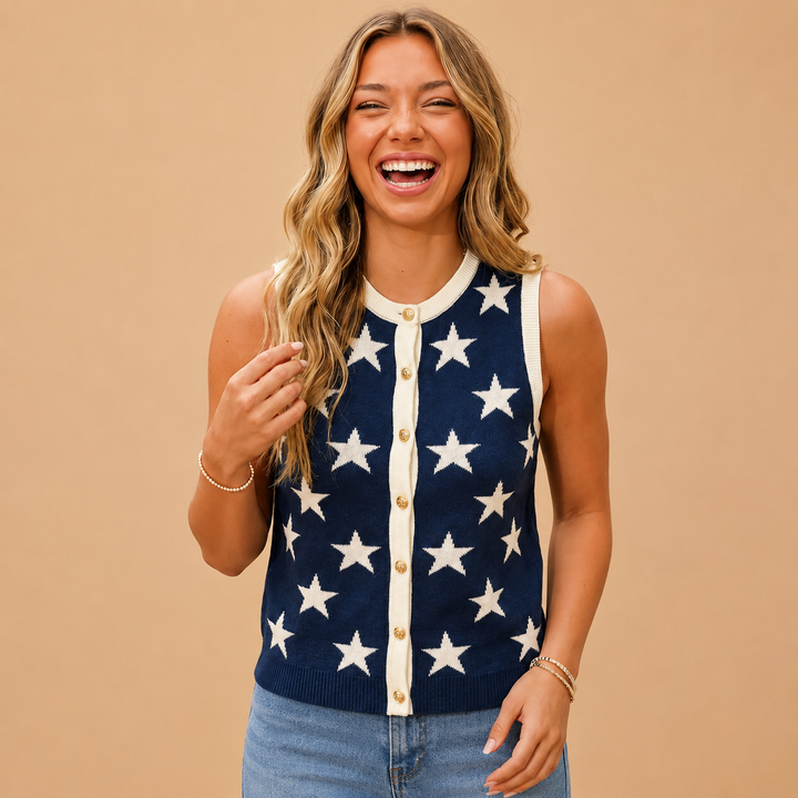 Woman wearing a navy cardigan with white star patterns on a beige background