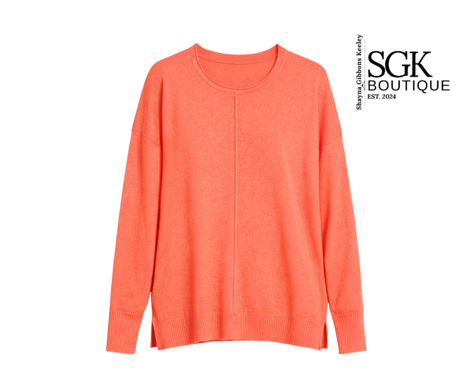 Coral sweater on a white background with SGK Boutique logo.