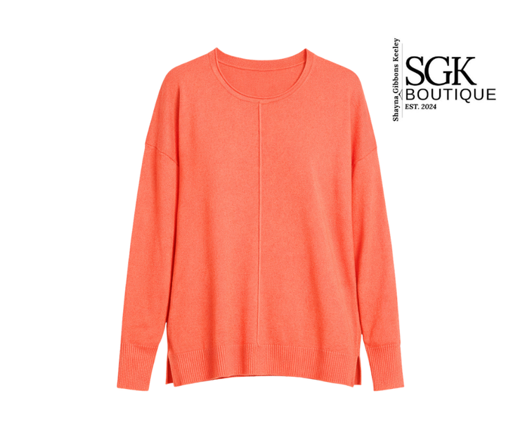 Coral sweater on a white background with SGK Boutique logo.