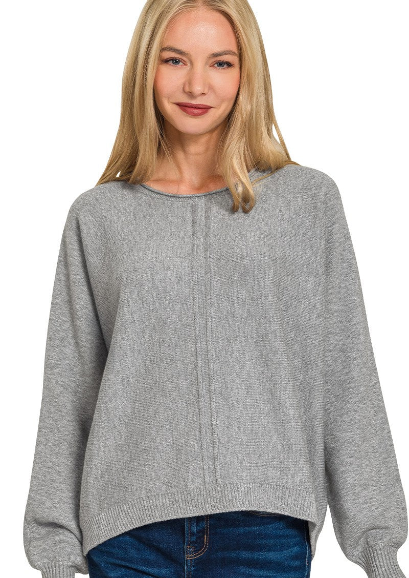 Woman wearing a gray sweater on a white background
