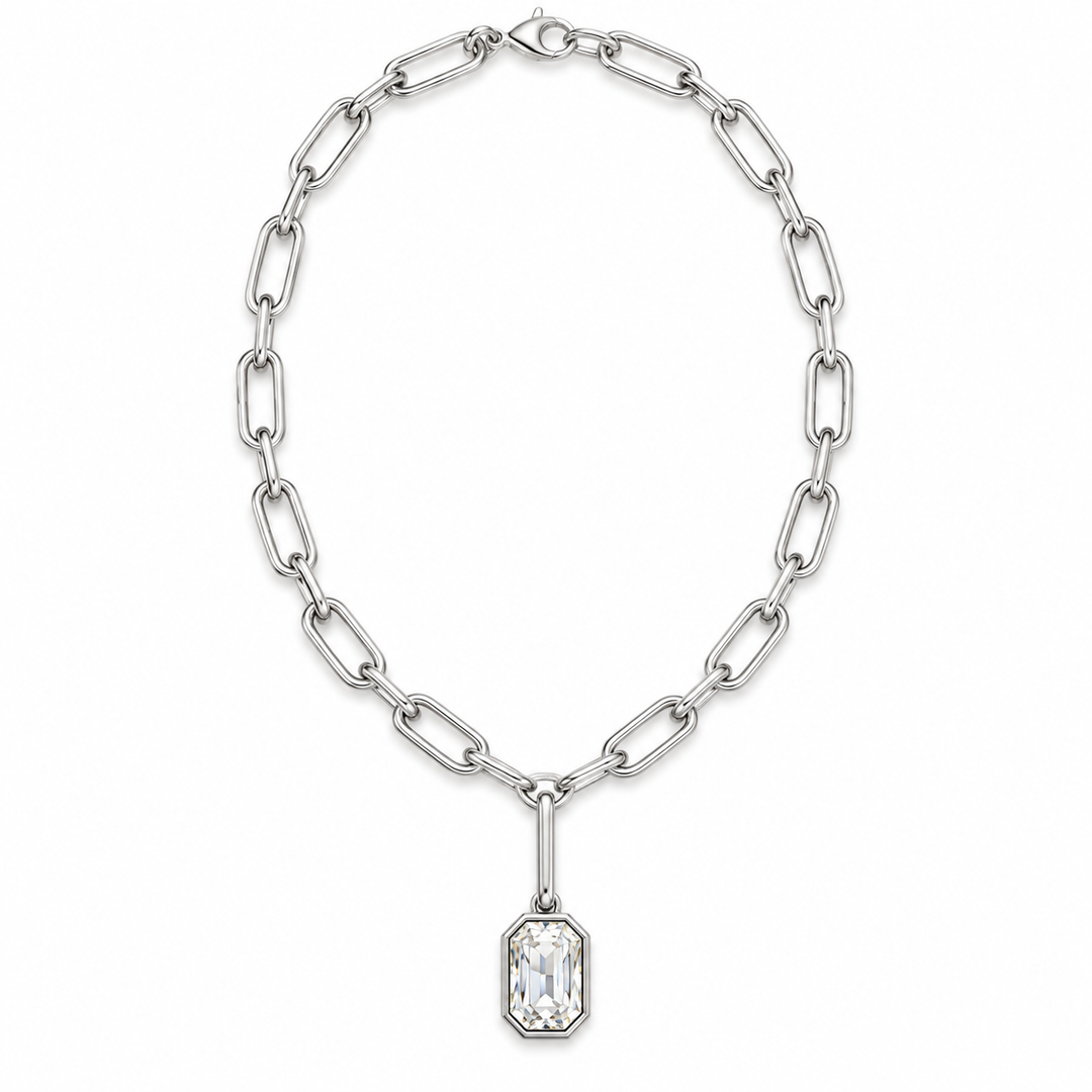 A silver paperclip chain necklace with a rectangular clear crystal pendant, displayed on a clean white background.