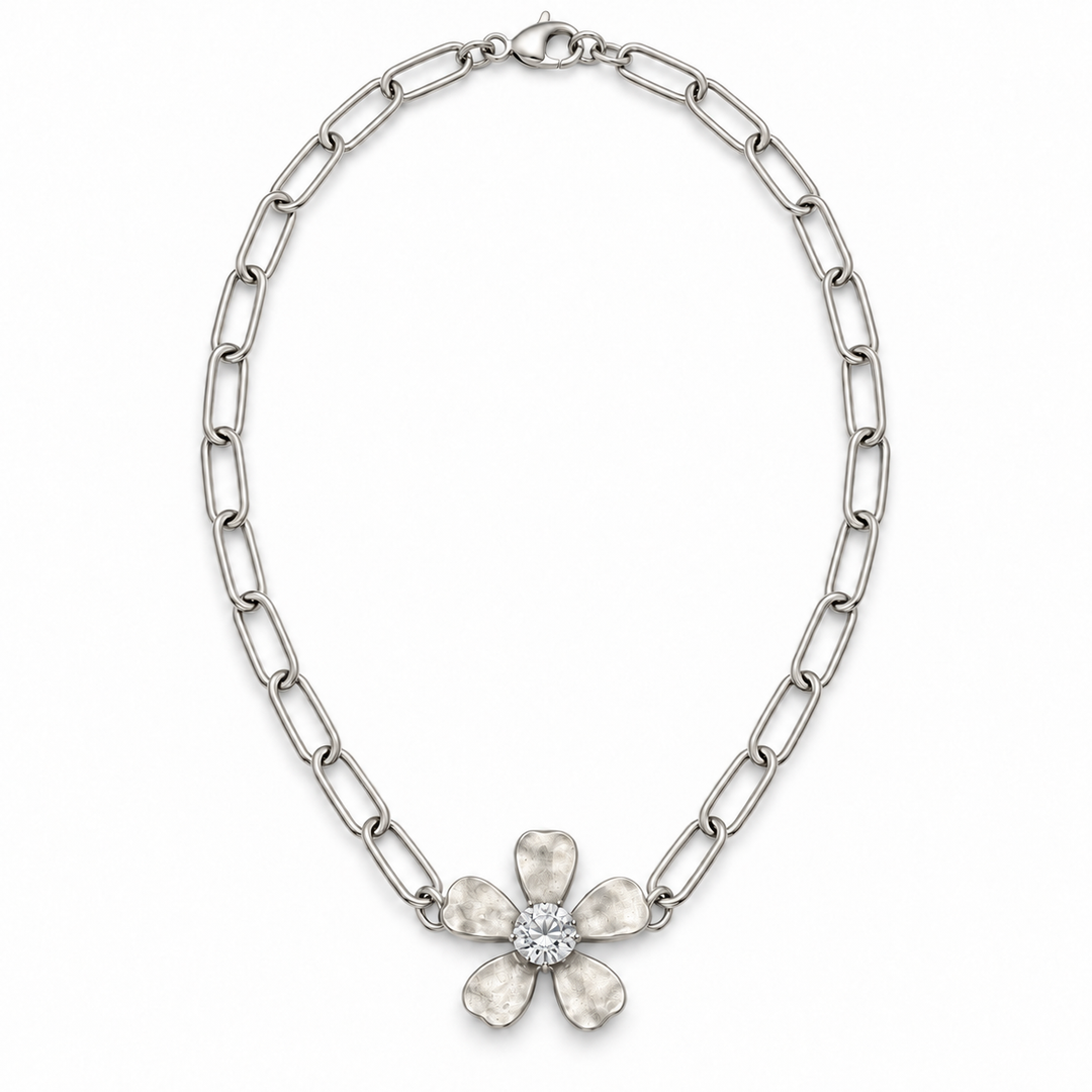 A silver-toned chain necklace featuring a flower-shaped pendant with five textured petals and a clear central stone, shown on a plain white background.