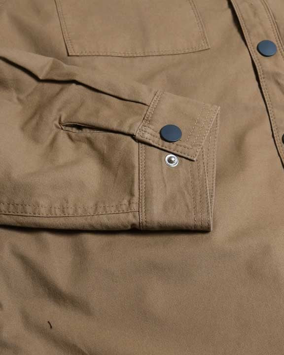 Close-up of a brown jacket with button details