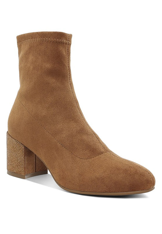 Brown suede ankle boot with block heel on a white background